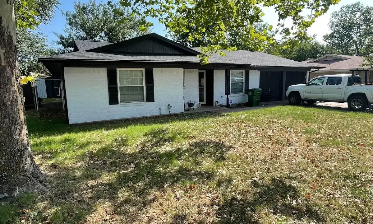Professional roofing crew working on a residential roof in Connellsville